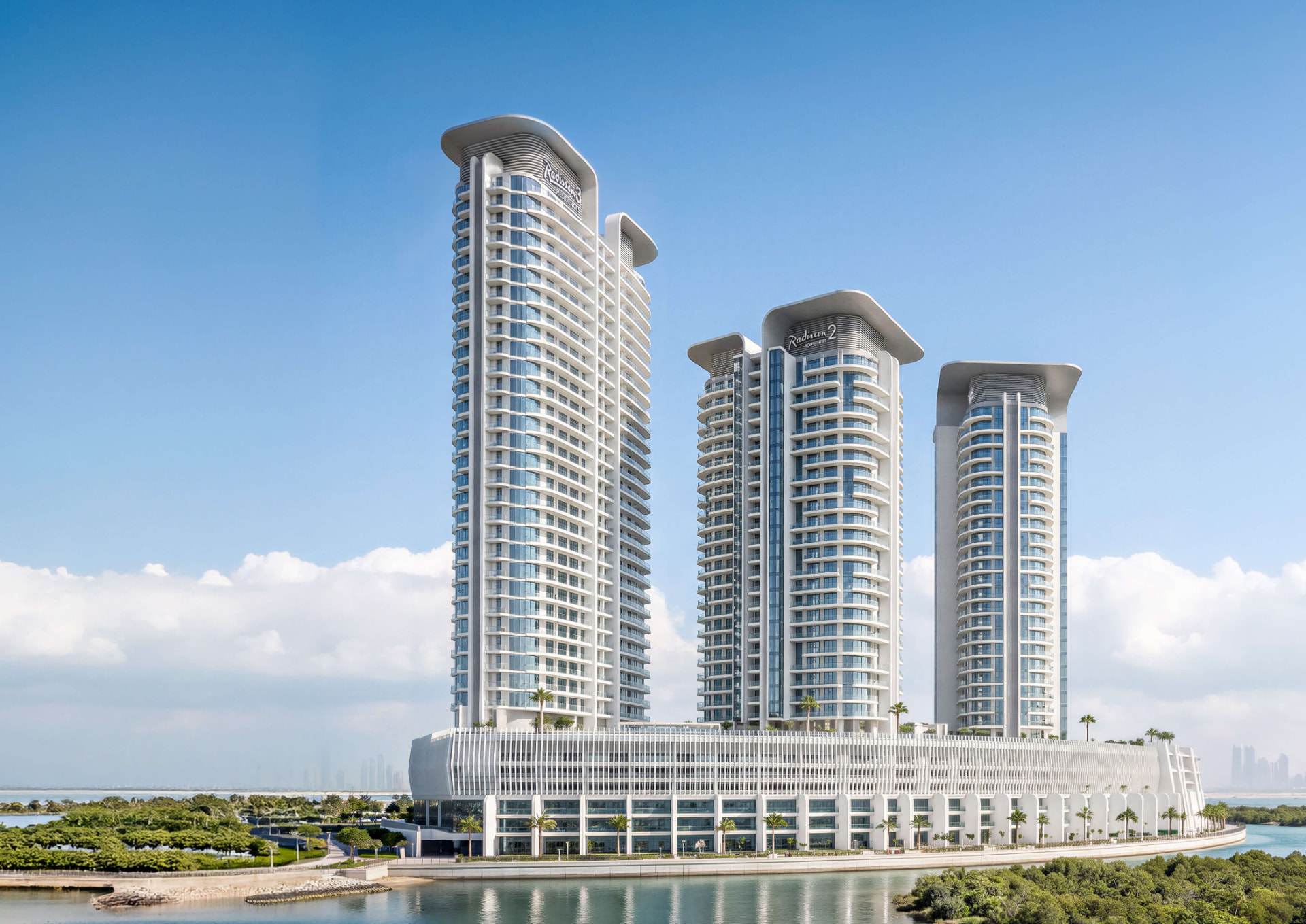 The three Radisson Residences towers above the shared podium, seen across the water