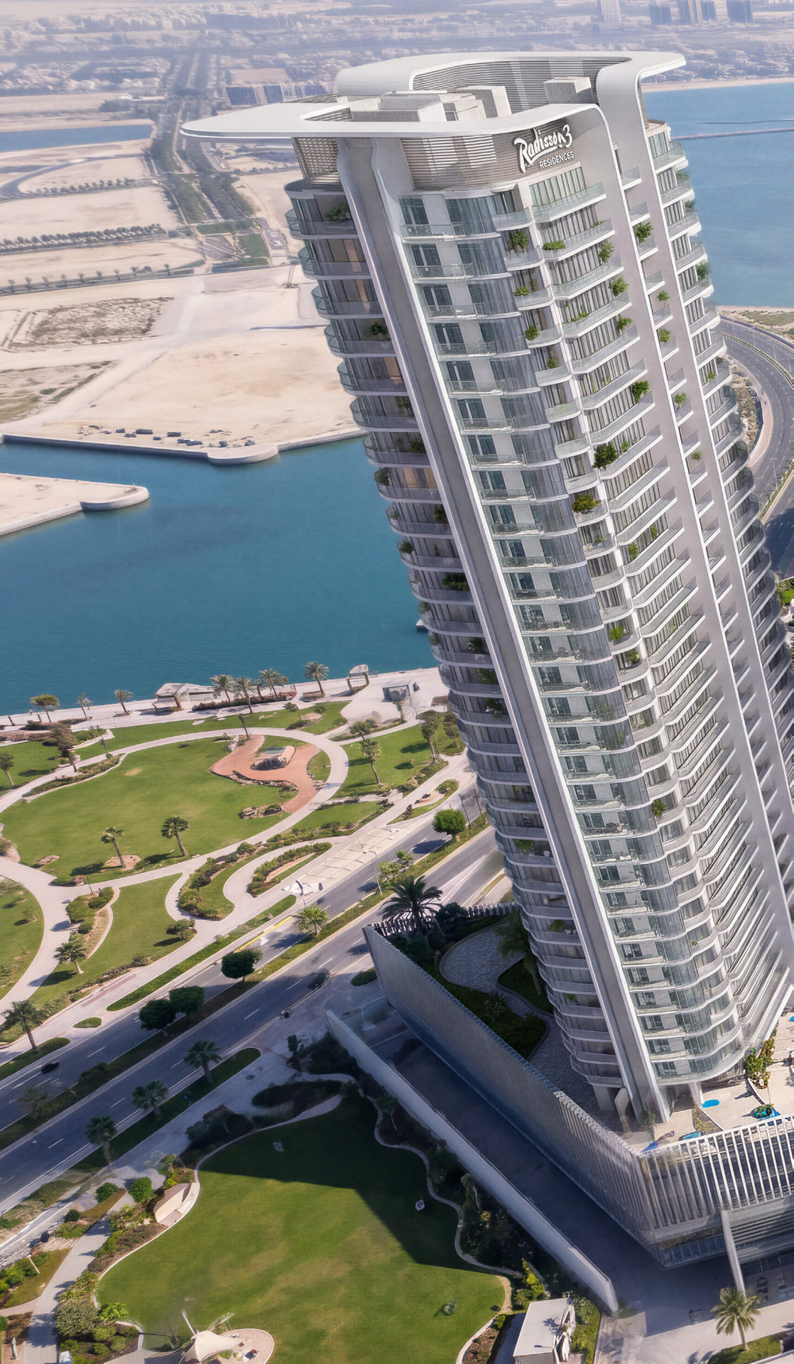 The three towers and shared waterfront podium seen across the water